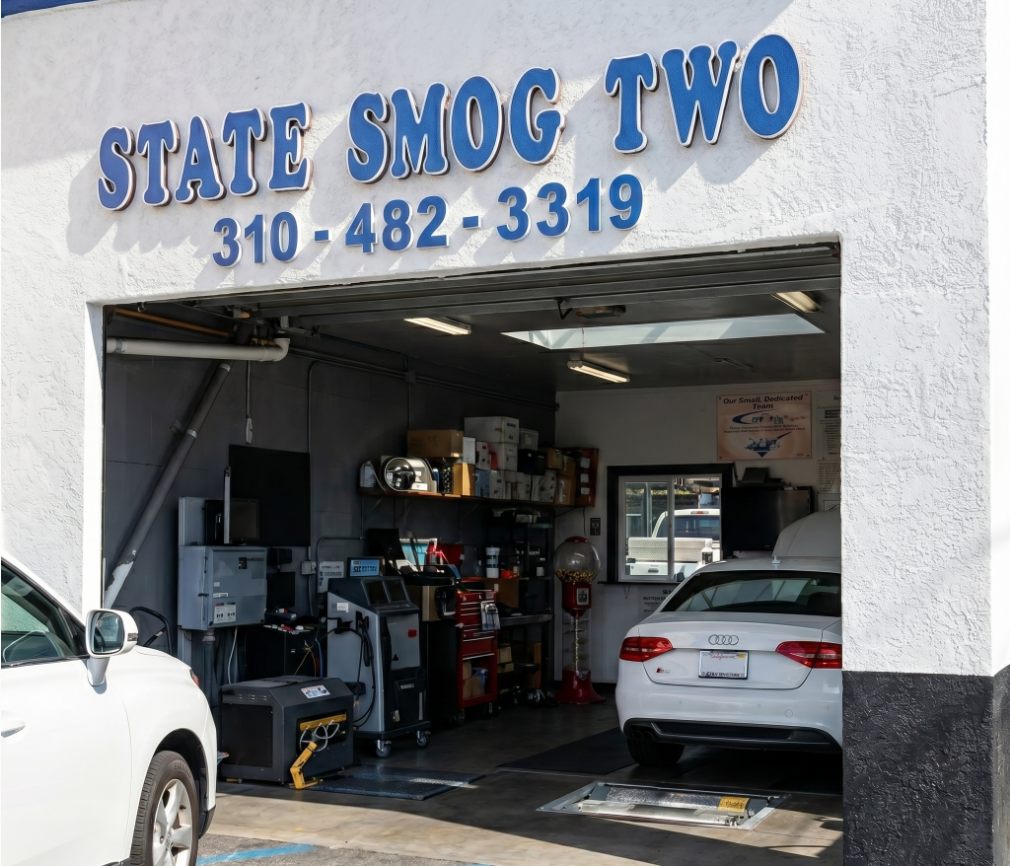 State Smog 2 inspection bay in Los Angeles with emissions testing equipment and vehicles